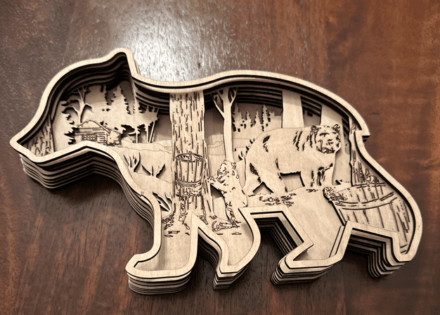 Intricately carved wooden puzzle shaped like a hippopotamus with animal figures inside.