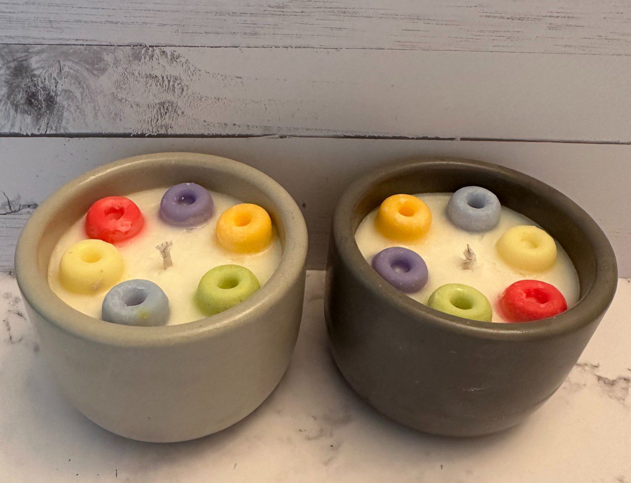 Two bowls filled with colorful, round, ring-shaped items.