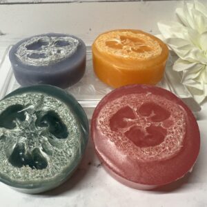 Four colorful, round soaps with floral imprints.