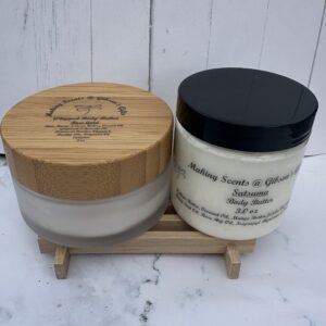 Two skincare jars displayed on a small wooden rack against a white background.