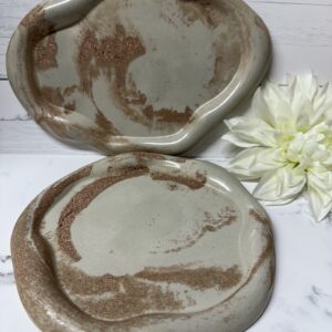 Two handmade ceramic plates with brown and beige marbled patterns.