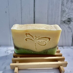 Handmade soap with layered colors and a decorative imprint.