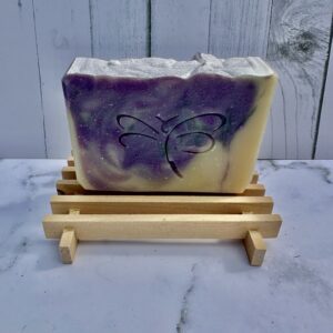 Handmade soap with purple and cream swirls and a butterfly design.