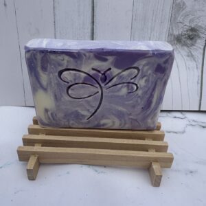 Handmade purple and white swirled soap bar with a butterfly design.