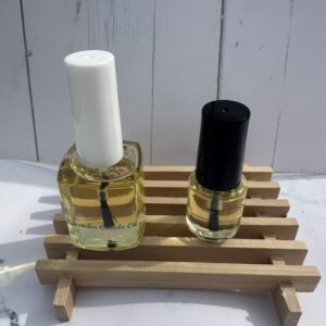 Two nail polish bottles on a small wooden rack against a white background.